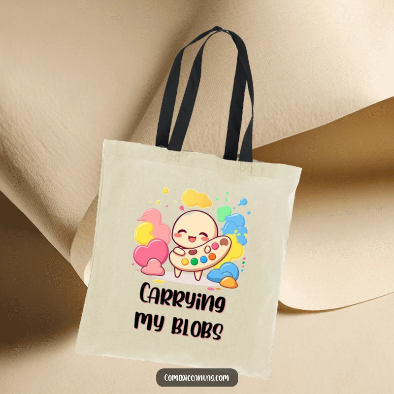 Funny tote bag designed with a giggling palette character happily playing with colorful paint blobs, perfect for art supplies.