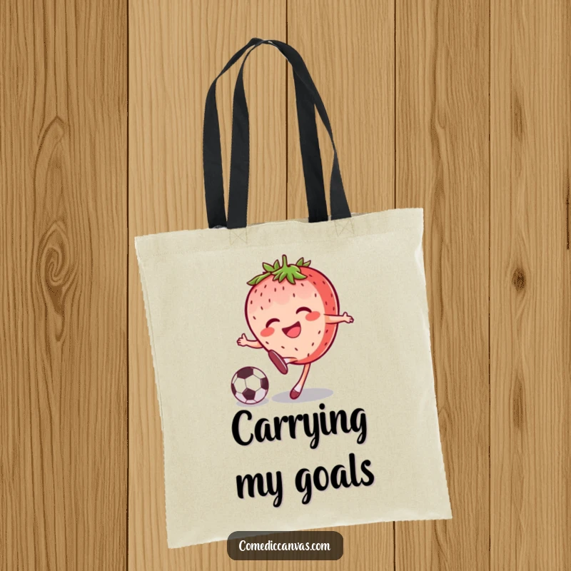 Funny joyful strawberry character kicking a soccer ball with a grin, printed on a sturdy tote bag for a fun carryall.