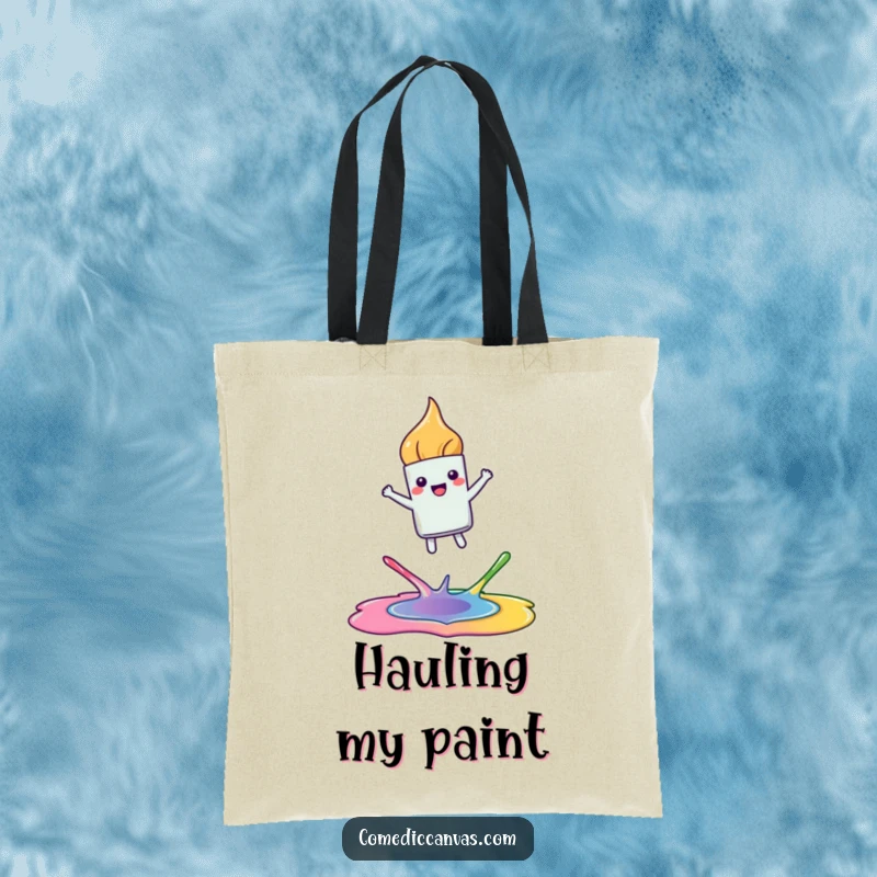 Funny tote bag depicting a happy, kawaii paintbrush leaping joyfully between colorful paint puddles, a humorous and practical accessory for artists.